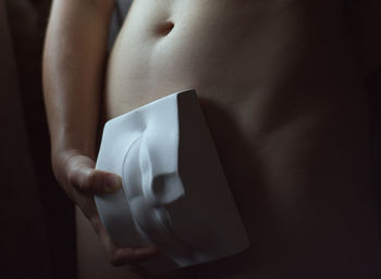 Close-up of man holding hands over white background