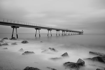 Bridge over sea against sky