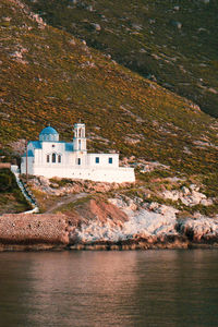 Church building on mountain by sea