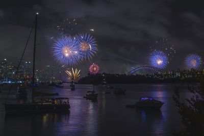 Firework display over river at night