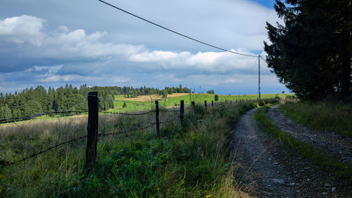 Fence on field against sky
