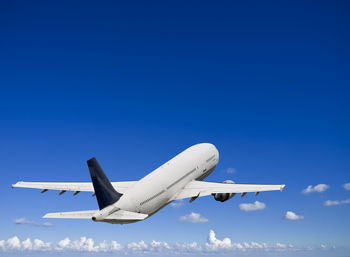 Civil jet airliner taking off into a blue sky