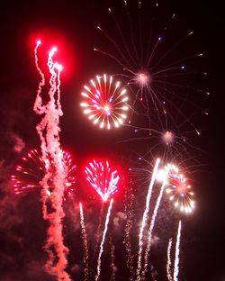 Low angle view of firework display at night