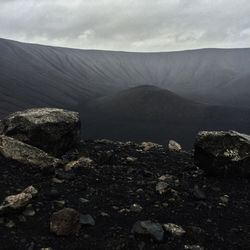 Scenic view of mountains against cloudy sky