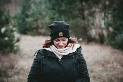 Portrait of young woman standing on field