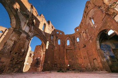 Low angle view of old ruin building against sky