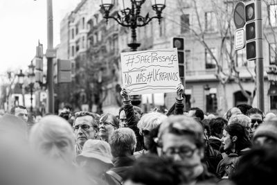 People walking on road against built structures