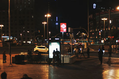 People on city street at night