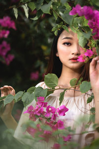 Portrait of woman with pink flowers