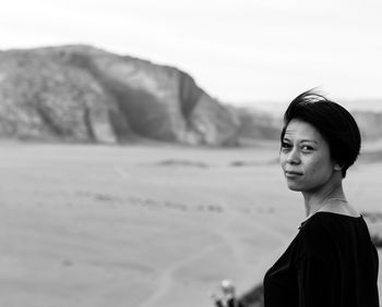 Portrait of woman on land against mountain