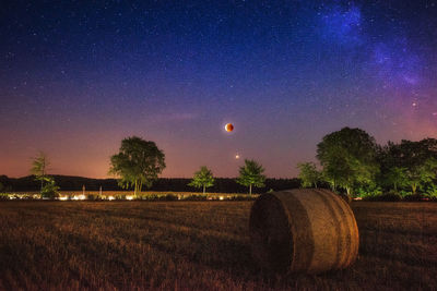 Scenic view of field against sky at night