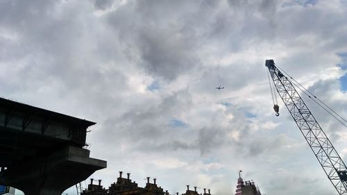 Low angle view of buildings against cloudy sky