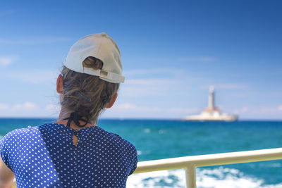 Rear view of woman against sea