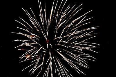Low angle view of firework display at night
