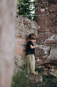 Full length of woman standing against wall