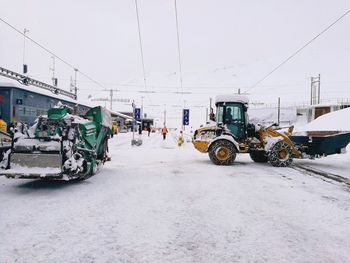 Bicycles on snow covered road against sky