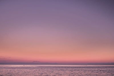 Scenic view of sea against romantic sky at sunset