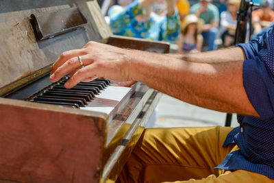 Midsection of man playing piano