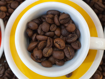 High angle view of coffee beans in bowl on table