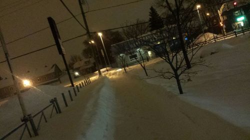 Snow covered road at night