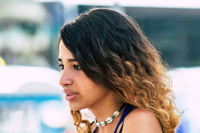 Close-up portrait of young woman looking away