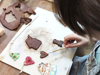 High angle view of girl drawing on table