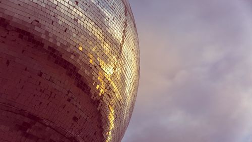 Low angle view of illuminated building against sky