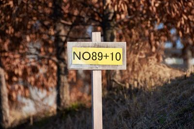 Close-up of sign against trees