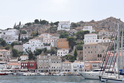 High angle view of townscape by sea against clear sky