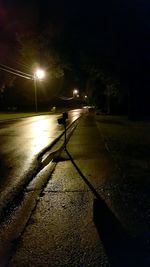 View of illuminated street lights at night