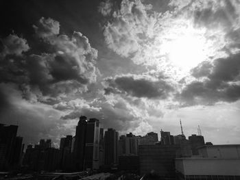 View of cityscape against cloudy sky