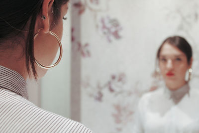 Portrait of young woman looking at home