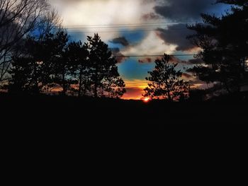 Silhouette trees against sky during sunset