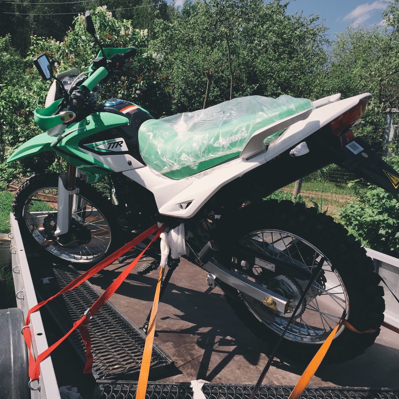 transportation, land vehicle, mode of transport, tree, bicycle, stationary, parking, sunlight, wheel, parked, high angle view, car, outdoors, day, no people, shadow, metal, motorcycle, travel, park - man made space