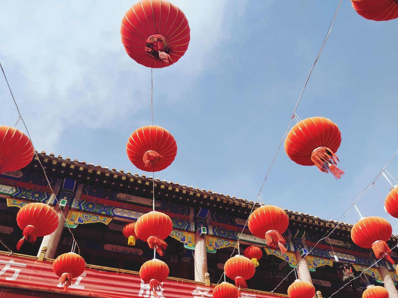 lantern, low angle view, chinese lantern, sky, lighting equipment, built structure, celebration, red, hanging, decoration, chinese new year, architecture, traditional festival, nature, chinese lantern festival, festival, day, no people, outdoors, paper lantern