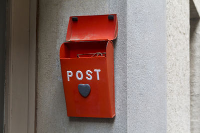 Close-up of red mailbox on wall