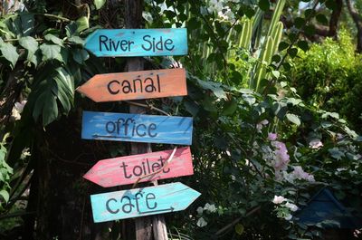 Close-up of information sign against plants