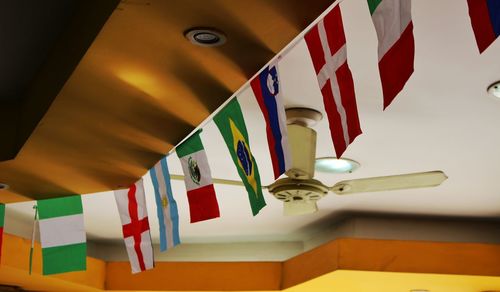 Low angle view of various flags hanging to ceiling