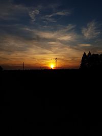 Silhouette landscape against sky during sunset