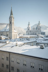 Salzburg cathedral and surrounding churches covered in snow on a sunny winter day