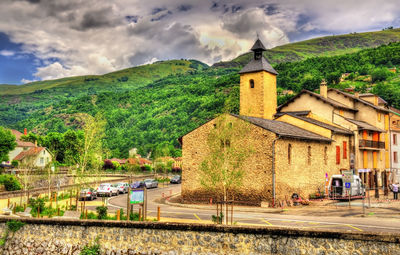 Panoramic view of trees and buildings against sky
