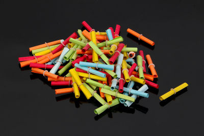 High angle view of multi colored pencils on black background