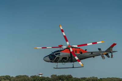 Low angle view of airplane against clear blue sky