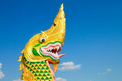 Low angle view of statue against blue sky