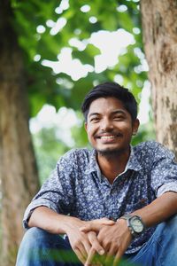 Portrait of smiling young man sitting outdoors