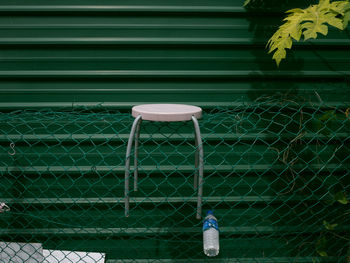 Close-up of table on chainlink fence