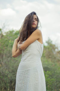 Portrait of beautiful woman standing on land