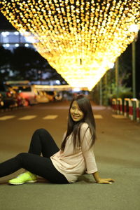 Portrait of young woman sitting outdoors