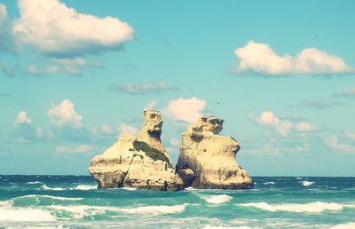 Scenic view of sea against cloudy sky