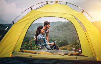 Couple sitting in tent